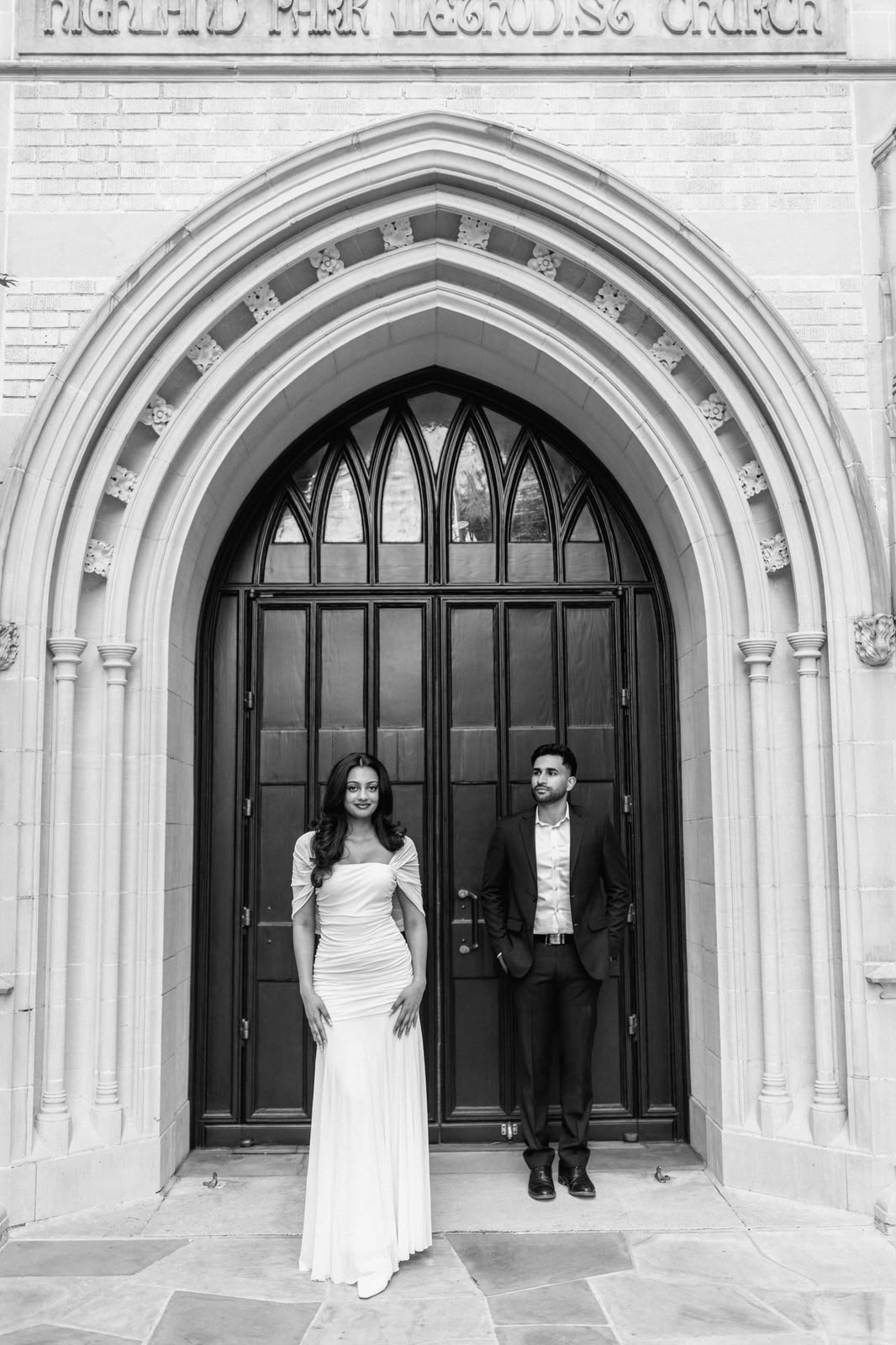 Angela and Ben stand beneath a grand arch
