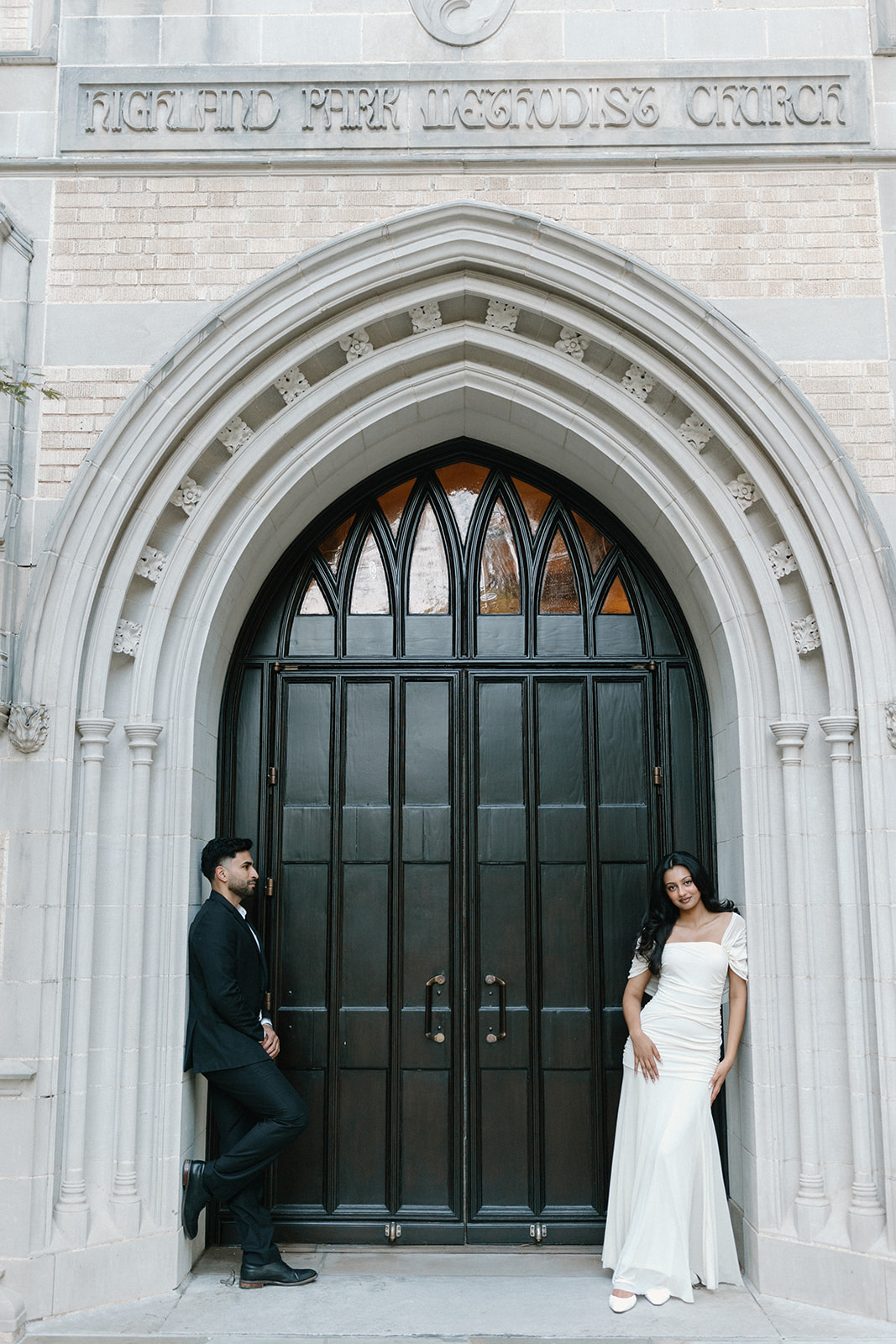 Angela and Ben standing on either side of the church doors