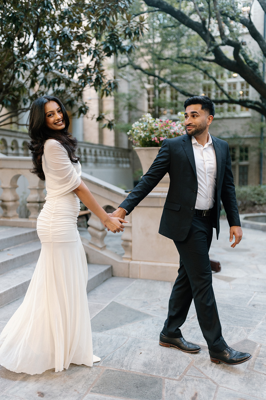 Angela and Ben holding hands beside the garden steps