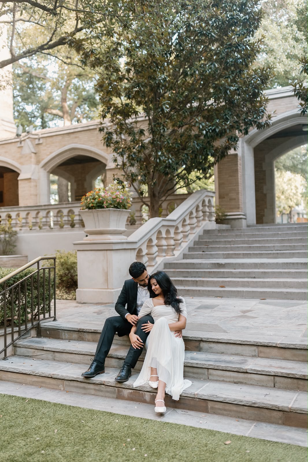 Angela and Ben sit together on stone steps
